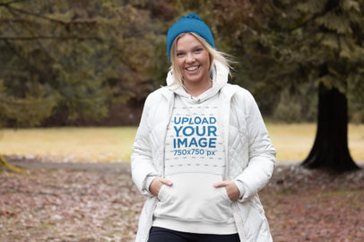 Pullover Hoodie Mockup Featuring a Joyful Woman in the Forest 