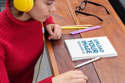 Mockup of a Woman Ready to Write on Her Notebook 29948