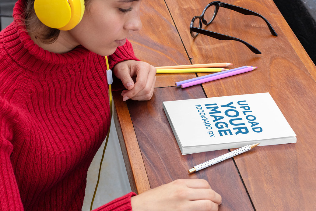 Mockup of a Woman Ready to Write on Her Notebook 