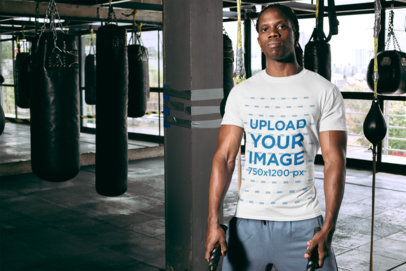 T-Shirt Mockup Featuring a Serious-Looking Man at a Boxing Gym