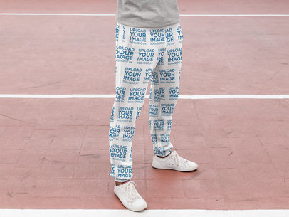 Sublimated Sweatpants Mockup Featuring a Man at a Running Track