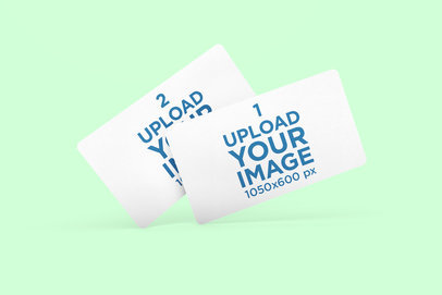 Mockup of Two Business Cards with Rounded Corners Floating Against a Plain Background