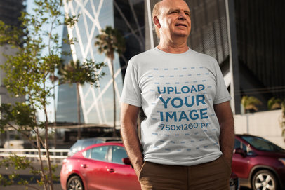 Mockup of an Elderly Man Wearing a T-Shirt Outdoors