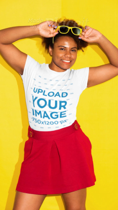 T-shirt Video of a Joyful Woman Posing in Front of a Solid Color Backdrop