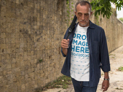 Elder Man Outdoors Wearing a T-Shirt and Carrying an Umbrella Mockup