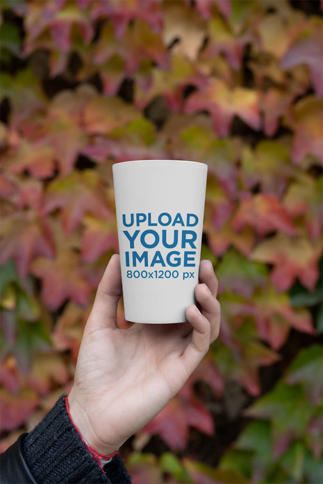 Mockup of a Reusable Cup with Autumn Leaves in the Background 
