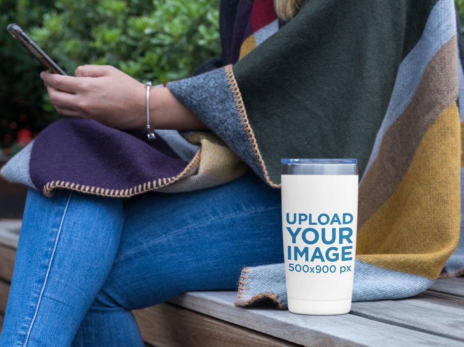 20 oz Travel Mug Mockup Featuring a Woman Looking at Her Phone