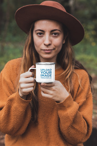 Mockup of a Woman in Nature Holding a 12 oz Enamel Mug