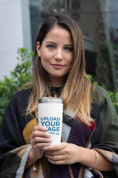 Mockup of a Woman Holding a 20 oz Travel Mug