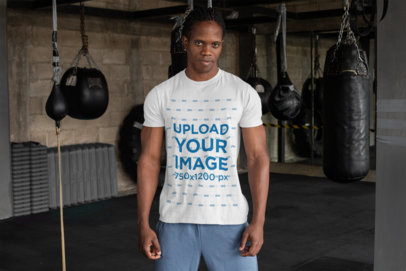 T-Shirt Mockup Featuring a Tough-Looking Man at a Boxing Gym