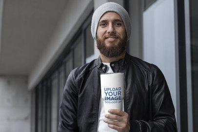 Mockup of a Man Holding a Travel Mug in Winter 30380