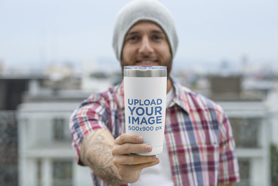 Mockup of a Bearded Man Showing His 20 oz Travel Mug to the Camera 