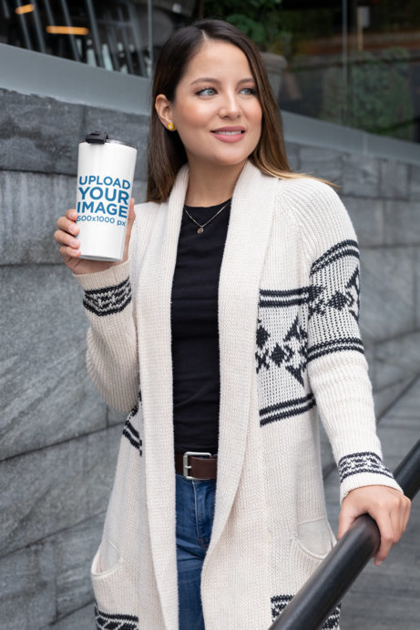 Mockup of a Woman Walking in the City with a Travel Mug