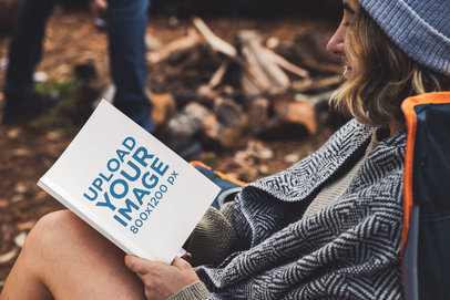 Book Mockup Featuring a Woman Reading in a Camping Site 30506