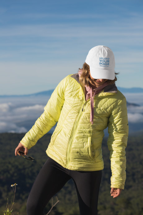Mockup of a Hiker Wearing a Dad Hat at the Mountains 