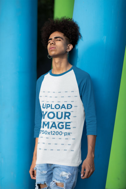 Three-Quarter Sleeves Raglan Tee Mockup Featuring a Young Man Leaning Against a Colorful Column 30221
