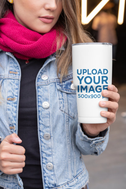 Mockup of a Cropped Face Woman Holding a 30 oz Travel Mug in the City 30422