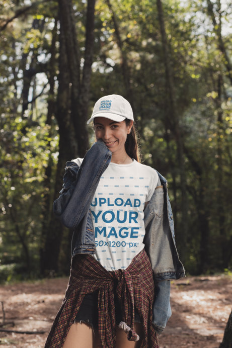 T-Shirt Mockup of a Woman Wearing a Dad Hat in the Woods