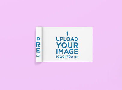 Mockup of a Rolled Magazine Lying on a Solid Color Surface 