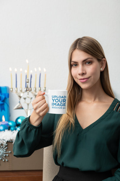 Mockup of a Woman Holding an 11 oz Coffee Mug in Hanukkah