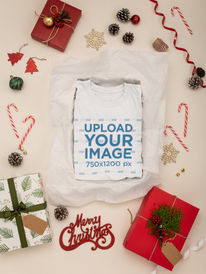 Mockup Featuring a Folded T-Shirt Surrounded by Xmas Decorations 