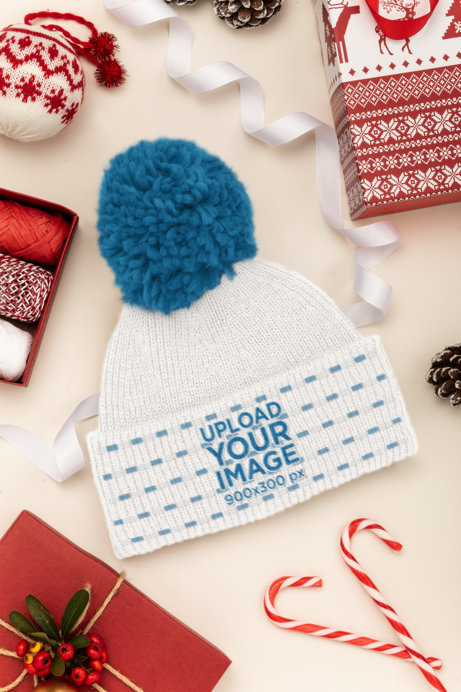 Mockup of a Beanie Surrounded by Christmas Decorations