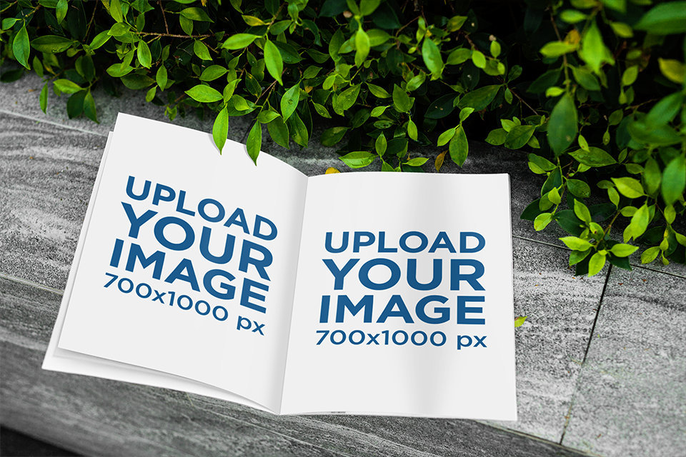  Mockup Featuring an Open Magazine by Some Shrubs 