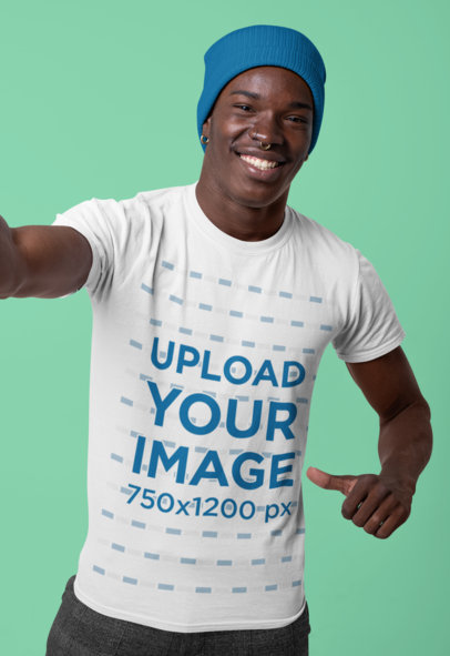 Mockup of a Happy Man Showing off His T-Shirt at a Studio 
