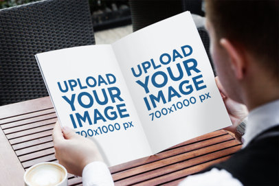 Mockup Featuring a Man Reading a Magazine at a Cafe 