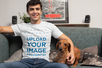 T-Shirt Mockup of a Man in the Living Room with His Dog