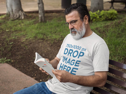 Hispanic Senior Wearing a T-Shirt While Reading Outdoors Mockup