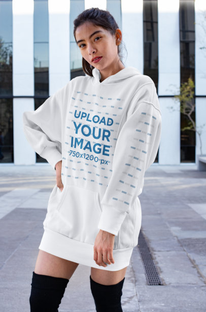 Mockup of a Woman Wearing a Hooded Dress with a Customizable Sleeve in an Urban Scenario 30521