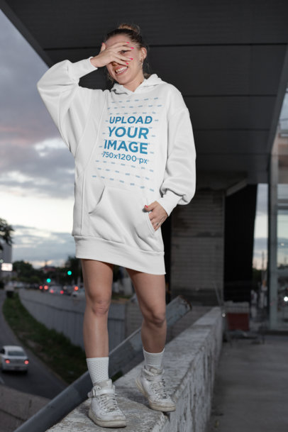 Mockup of a Happy Woman Wearing a Hoodie Dress in the Street