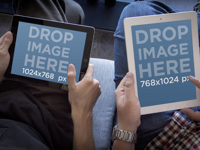 Mockup of Two Friends Holding iPads