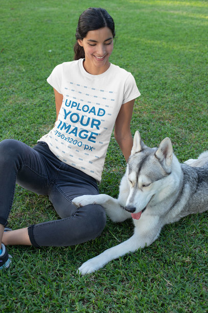 T-Shirt Mockup of a Woman Sitting on the Grass with Her Dog