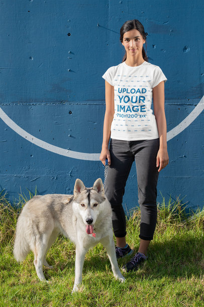 T-Shirt Mockup of a Young Woman Standing Next to Her Dog 