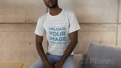 T-Shirt Video Featuring a Bearded Man Sitting on a Fabric Armchair 22538