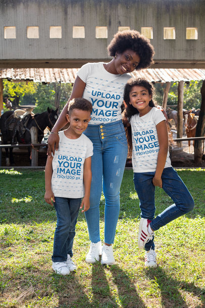 T-Shirt Mockup Featuring a Mother with Her Kids by a Barn