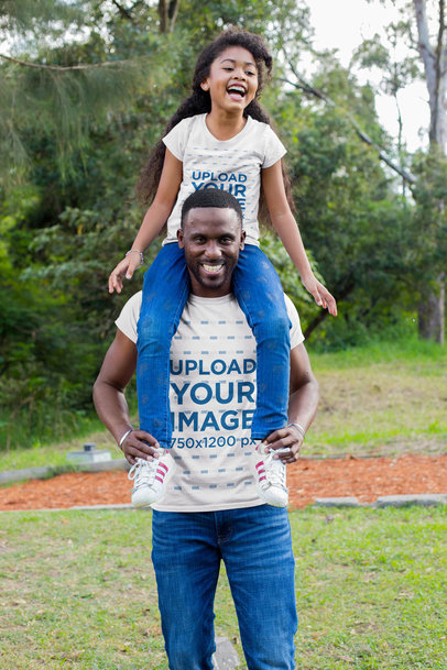 T-Shirt Mockup of a Man Carrying His Daughter on His Shoulders