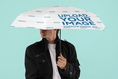 Mockup of a Man Holding an Umbrella at a Studio