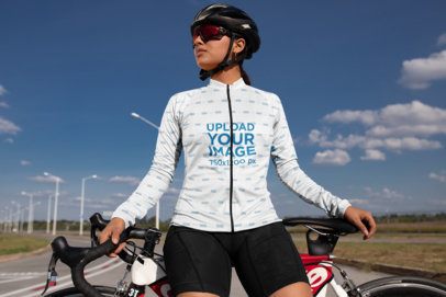 Long Sleeve Cycling Jersey Mockup Featuring a Woman Posing by Her Bike