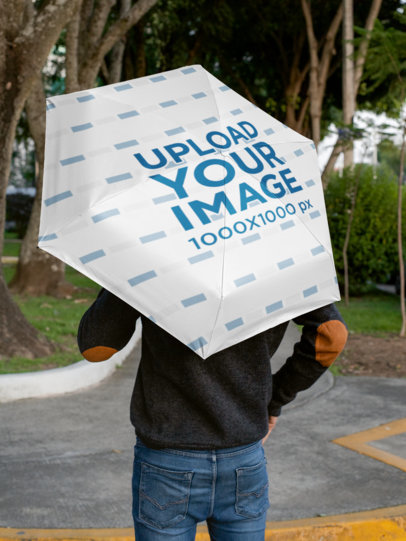 Back-View Mockup of a Man Holding an Umbrella