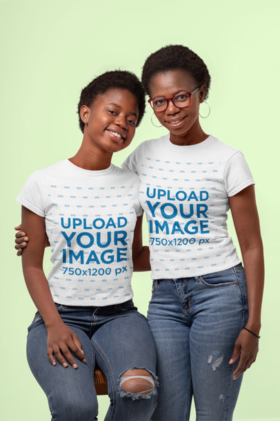 Mockup of a Mother and Daughter Wearing Matching T-Shirts at a Studio