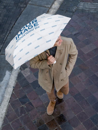 Zenith Shot Mockup Featuring a Smiling Man Holding an Umbrella