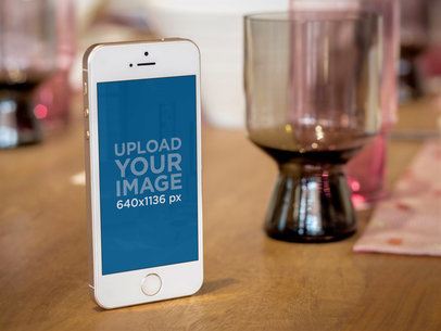 Mockup of a Gold iPhone 5s Standing on a Table 