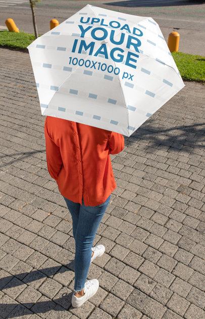 Top View Mockup of a Woman Holding an Umbrella on the Street