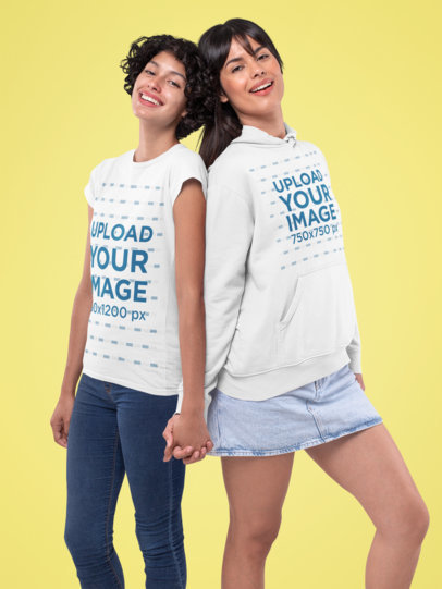 Mockup of a Couple Wearing a T-Shirt and a Pullover Hoodie at a Studio 