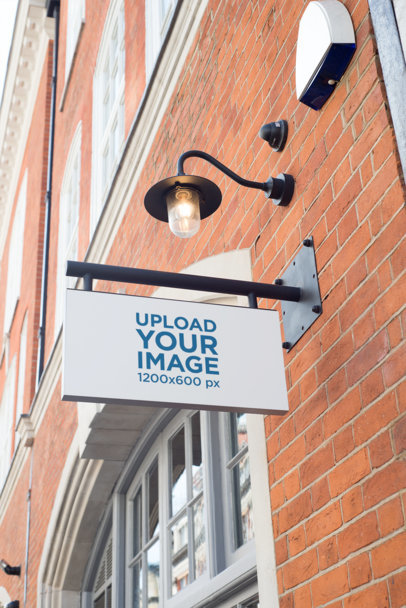Mockup of a Sign Attached to a Brick Wall