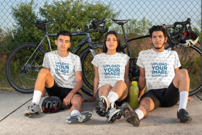 T-Shirt Mockup of Three Friends Sitting by Their Bicycles