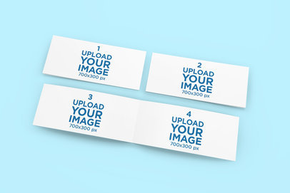 Mockup of a Set of Three Greeting Cards Lying Against a Flat Background